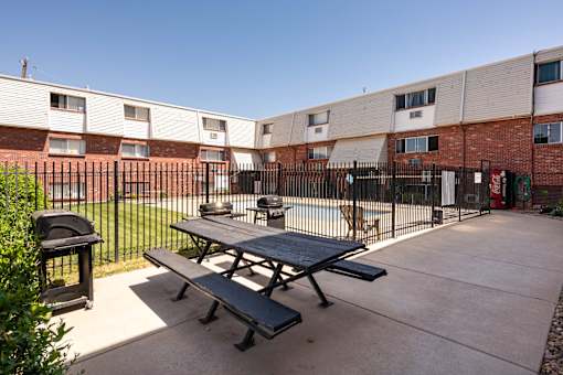 our apartments have a patio with a picnic table and a grill
