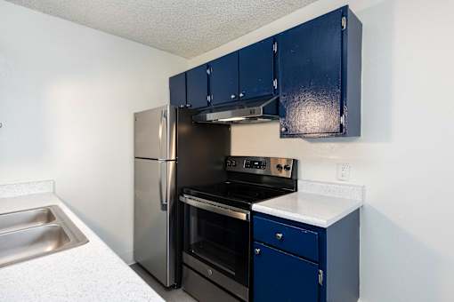 kitchen with navy cabinets and a black refrigerator