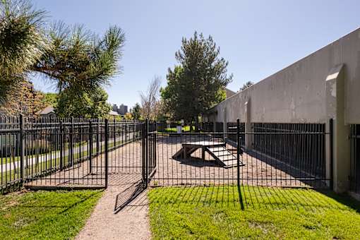 a fenced in area with a fire pit and a fence
