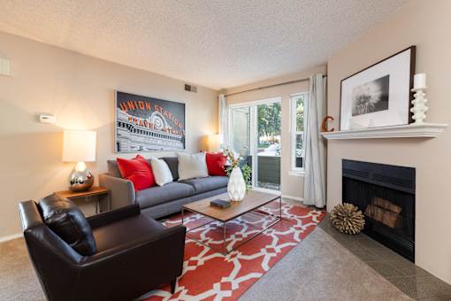 a living room with a couch and a coffee table and a fireplace