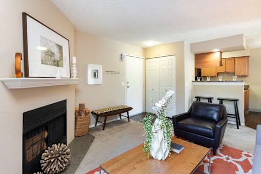 a living room with a fireplace and a couch and a table
