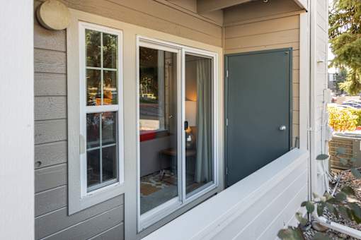 the front of the house has three windows and a door