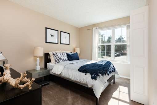a bedroom with a bed and a window