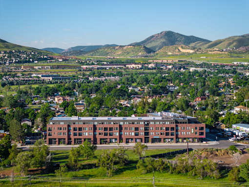 A large red building sits in the middle of a green field.