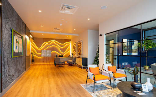 A modern living room with a wooden floor and a large window.