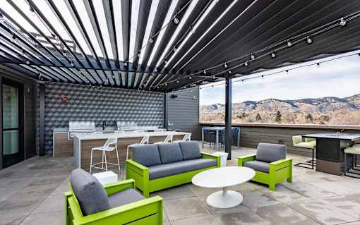 A modern outdoor seating area with a view of the mountains.