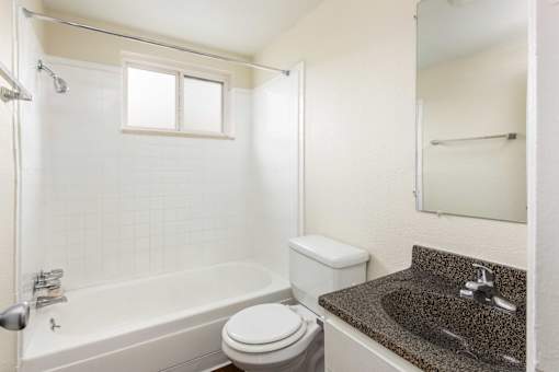 a bathroom with a sink toilet and bath tub