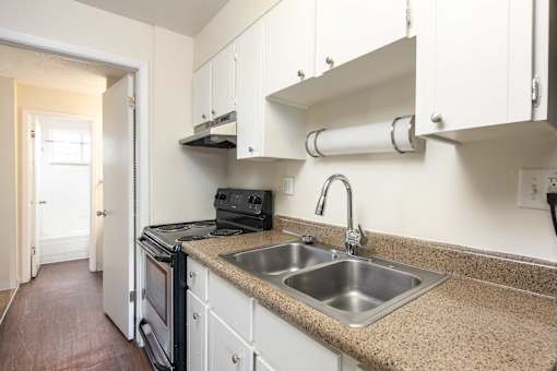 a kitchen with a sink and a stove and a window