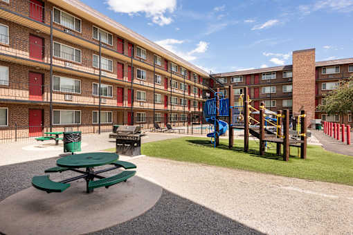a playground in the courtyard of an apartment building