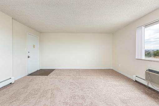 an empty room with a door and a window