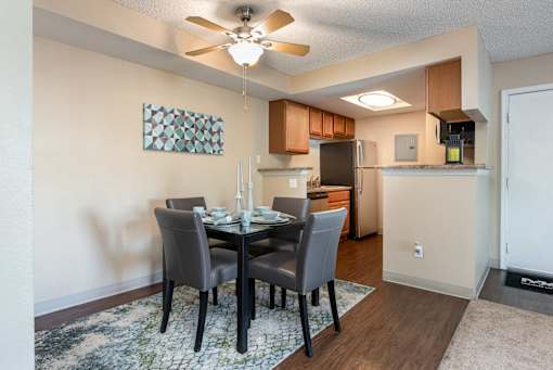 a dining room with a table and chairs and a kitchen