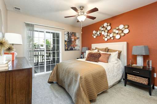 a bedroom with a bed and a ceiling fan