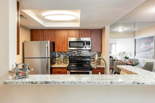 a kitchen with stainless steel appliances and granite counter tops