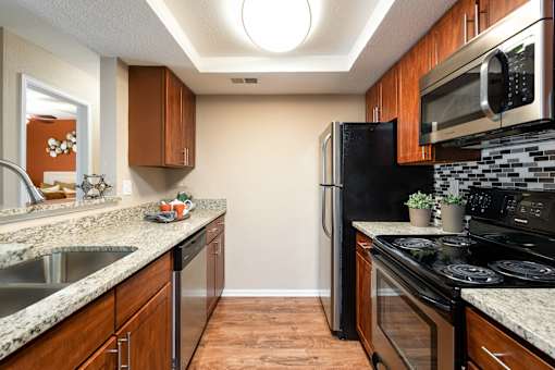 a kitchen with stainless steel appliances and granite counter tops