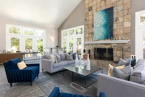 a living room with couches and chairs and a fireplace