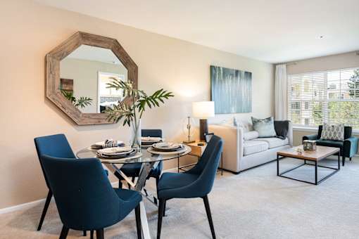 a living room with a dining room table and a couch
