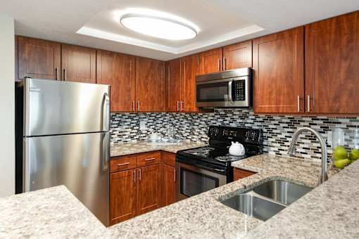 a kitchen with granite counter tops and stainless steel appliances