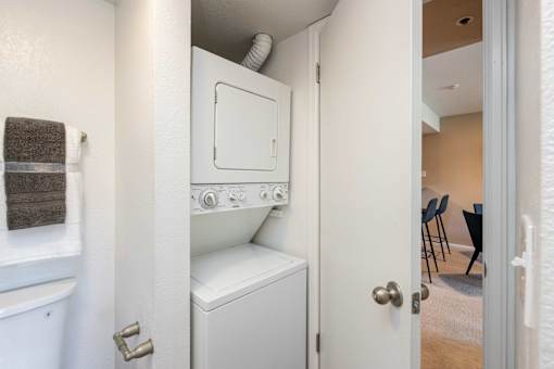 a washer and dryer in a small closet in a room with a door