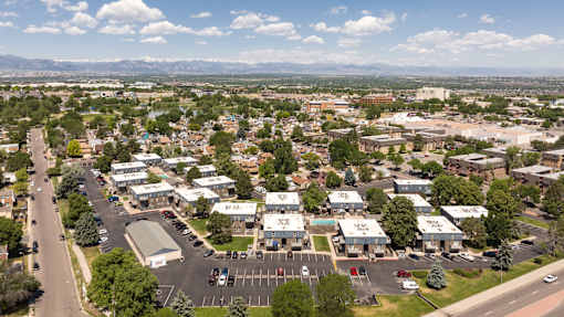 an aerial view of a suburb of a city with a road and cars