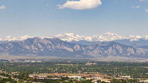 a view of the mountains in the distance with a city in the foreground