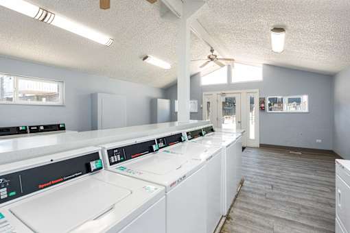 a laundry room with washes and dryers in it
