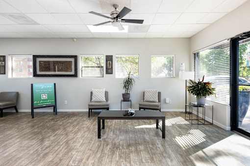 the preserve at ballantyne commons community room with seating and a ceiling fan