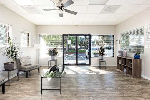 a living room with a ceiling fan and a sliding glass door