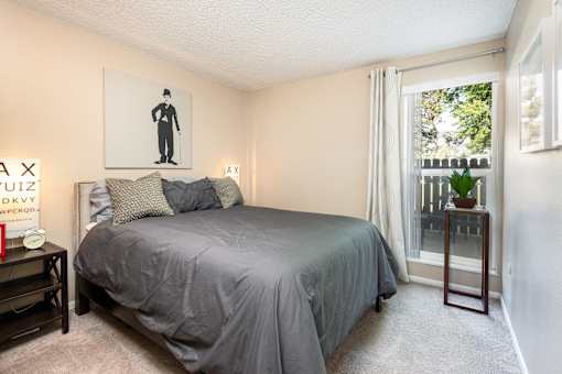 a bedroom with a bed and a large window