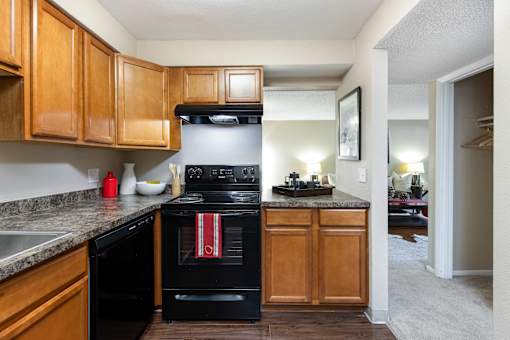 a kitchen with black appliances and wooden cabinets
