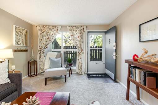 an open living room with a door to a balcony