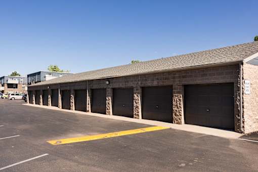 the outside of a building with garages and a parking lot