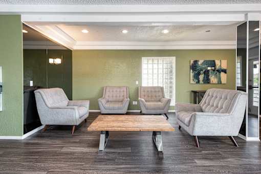 a waiting room with four chairs and a coffee table