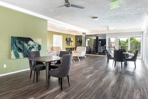 a living room and dining room with chairs and a table