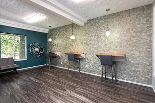 a community room with three tables and chairs and a window