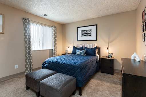 a bedroom with a bed and a dresser and a window