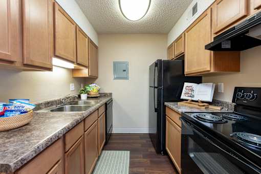 our apartments have a modern kitchen with granite counter tops and black appliances