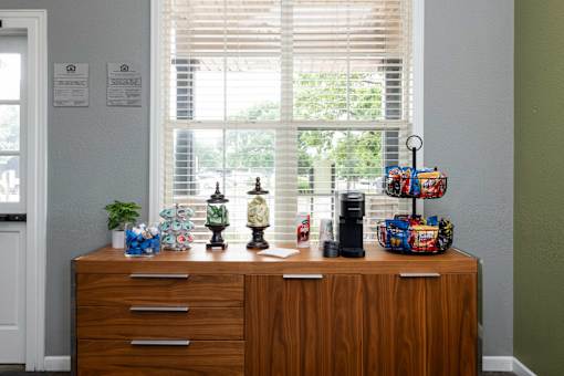 a wooden dresser in front of a window