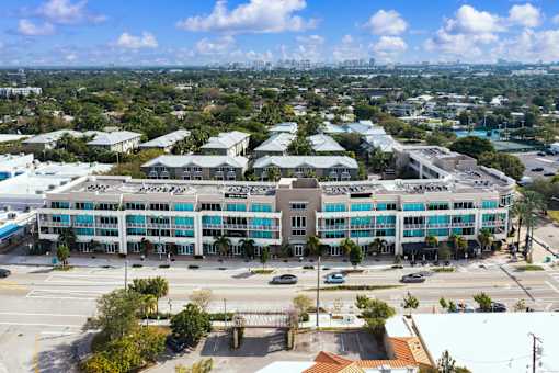 an aerial view of a building with a city in the background
