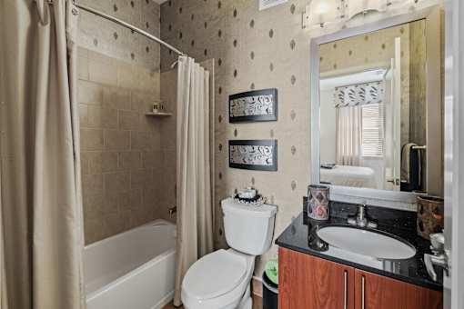 a bathroom with a sink toilet and a shower