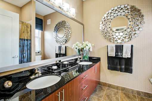 a bathroom with two sinks and a large mirror