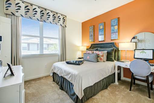 a bedroom with a bed and a desk