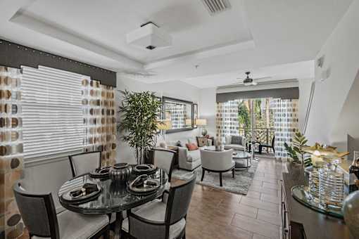 a dining room and living room with a table and chairs
