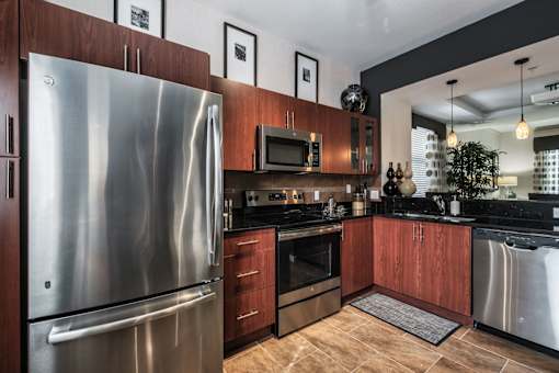 a kitchen with stainless steel appliances and wooden cabinets