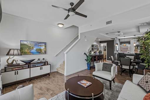 a living room with furniture and a ceiling fan