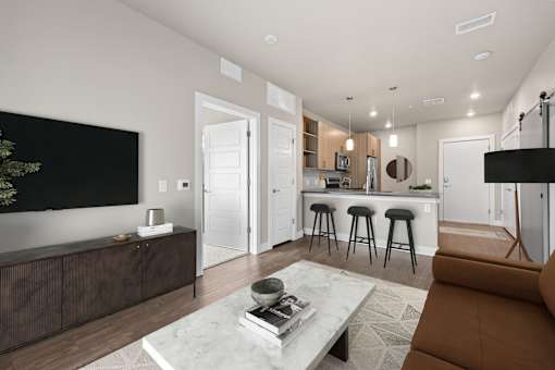 A modern living room with a brown sofa and a coffee table.