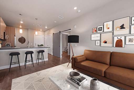 A living room with a brown couch and a white rug.