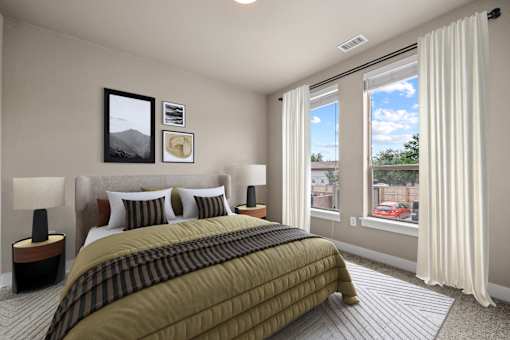 A bedroom with a large bed and a window overlooking a red car.