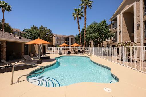 our apartments have a resort style pool with chairs and umbrellas