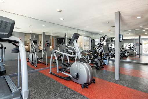 a gym with various exercise bikes and other fitness equipment