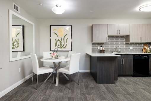 a dining room with a table and chairs next to a kitchen